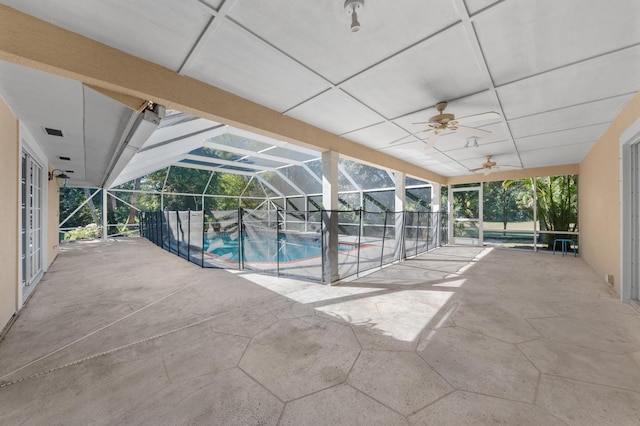 view of swimming pool featuring a patio area, ceiling fan, and glass enclosure