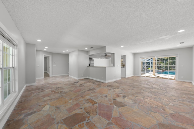 unfurnished living room with a textured ceiling