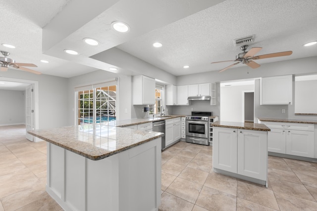 kitchen with white cabinetry, stainless steel appliances, and a center island