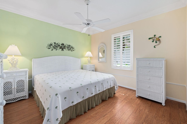 bedroom with ceiling fan, ornamental molding, and hardwood / wood-style floors