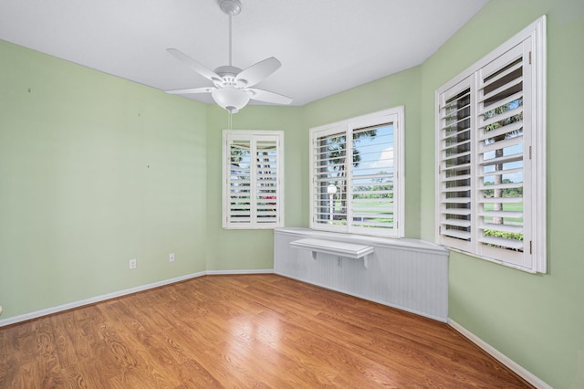 empty room featuring ceiling fan and light wood-type flooring