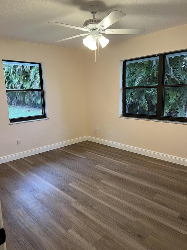 spare room with ceiling fan, a textured ceiling, and dark hardwood / wood-style flooring