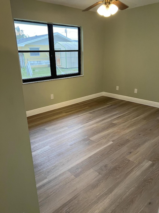 unfurnished room with wood-type flooring and ceiling fan