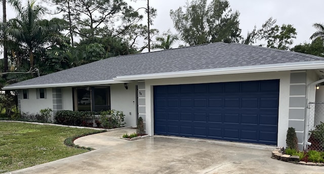 ranch-style house featuring a garage and a front yard