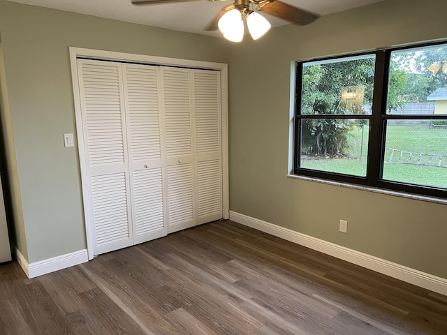 unfurnished bedroom featuring wood-type flooring, a closet, and ceiling fan