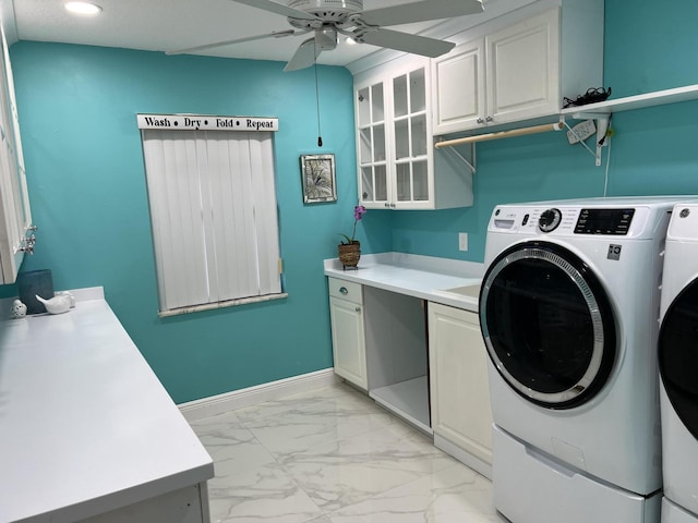 clothes washing area with ceiling fan, cabinets, and washing machine and clothes dryer