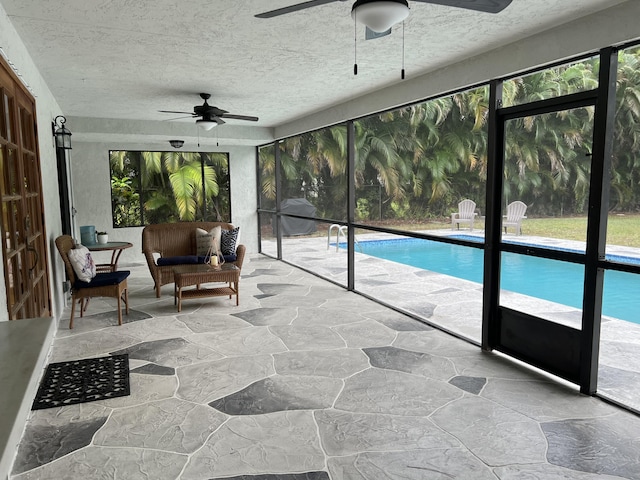 sunroom / solarium featuring ceiling fan