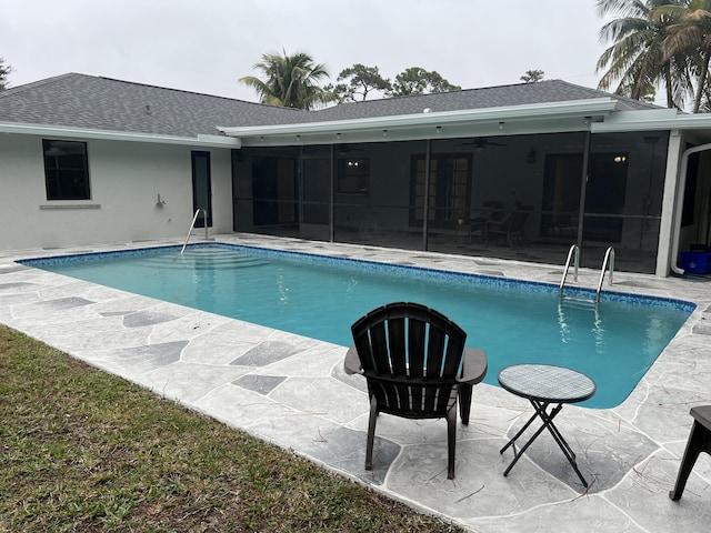 view of swimming pool with ceiling fan and a patio area