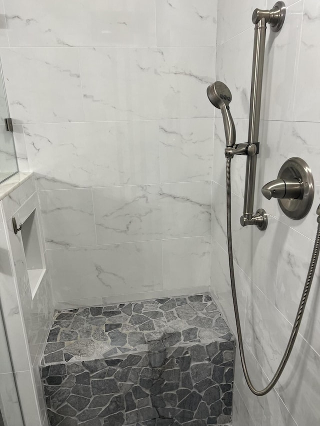 bathroom with a tile shower