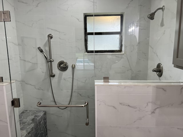 bathroom featuring a shower with shower door