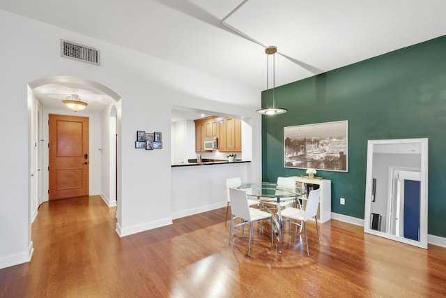 dining space with hardwood / wood-style flooring