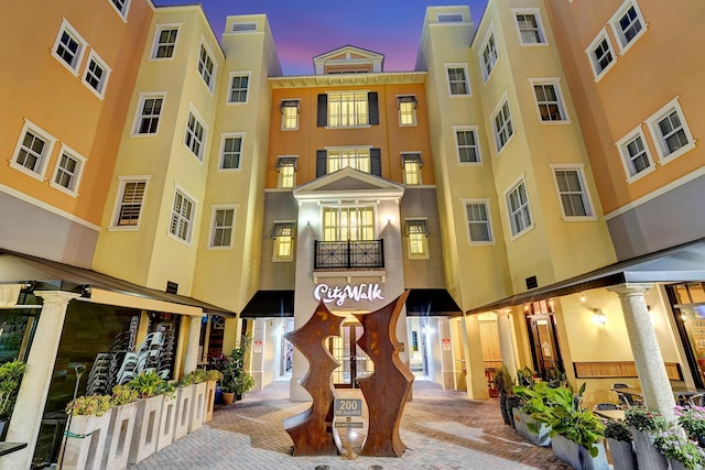 view of outdoor building at dusk