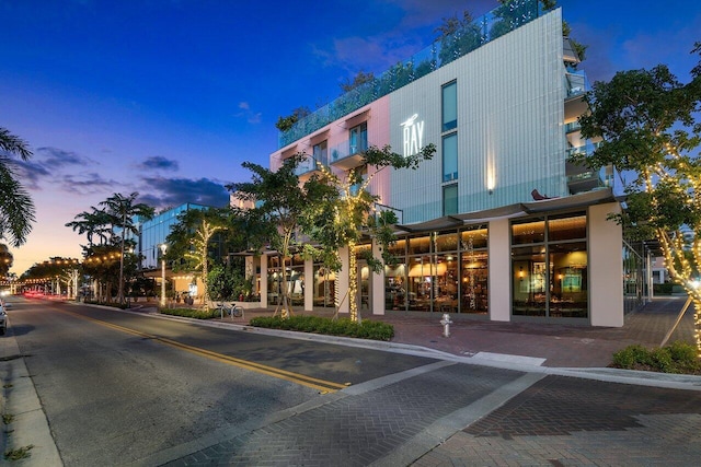 view of outdoor building at dusk