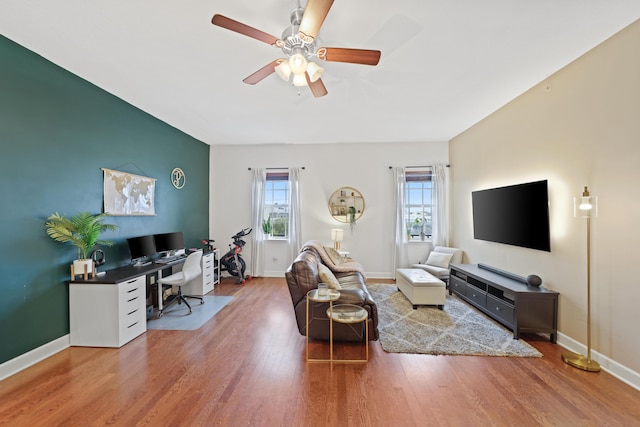 living room featuring hardwood / wood-style flooring and ceiling fan