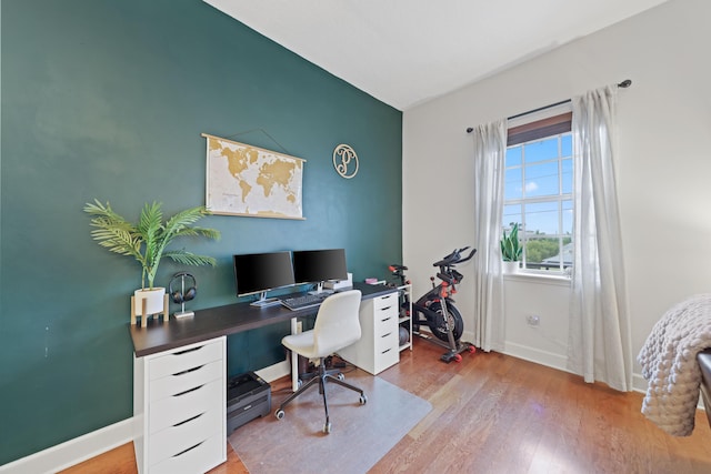 home office with hardwood / wood-style floors