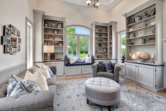 sitting room featuring light wood-type flooring and a notable chandelier