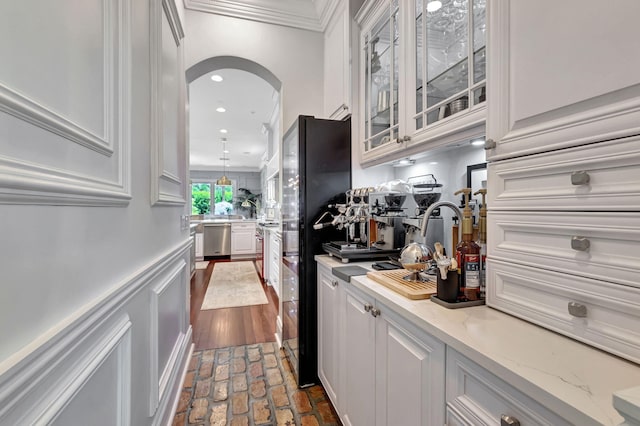 bar featuring white cabinetry, ornamental molding, dishwasher, and light stone countertops