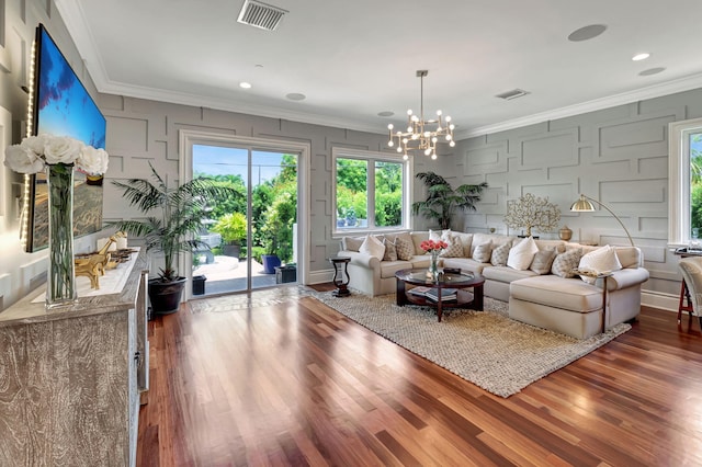 living room with crown molding, wood-type flooring, and an inviting chandelier