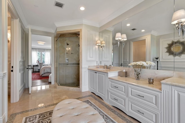 bathroom with crown molding, vanity, and a shower with door