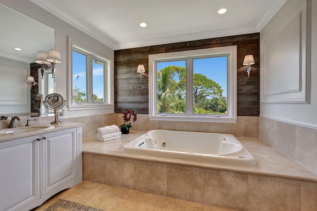 bathroom with a relaxing tiled tub, ornamental molding, and vanity