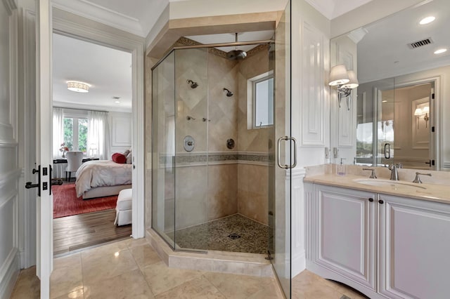 bathroom with crown molding, tile patterned floors, vanity, and an enclosed shower