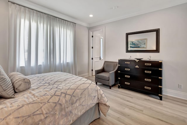 bedroom with ornamental molding and light wood-type flooring