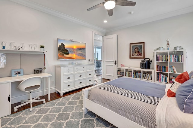 bedroom featuring dark hardwood / wood-style flooring, ornamental molding, and ceiling fan