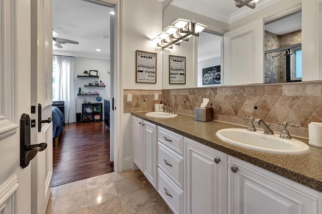 bathroom with decorative backsplash, ceiling fan, ornamental molding, and vanity