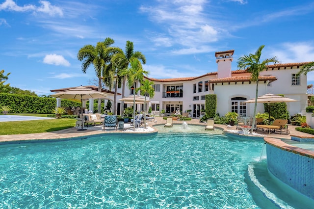 view of swimming pool with a patio and pool water feature