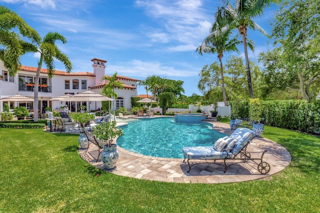 view of swimming pool featuring a yard and a patio