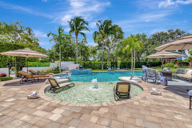 view of pool with pool water feature, a patio area, and a jacuzzi