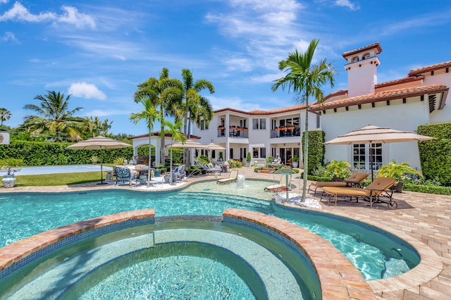 view of pool with a patio and an in ground hot tub