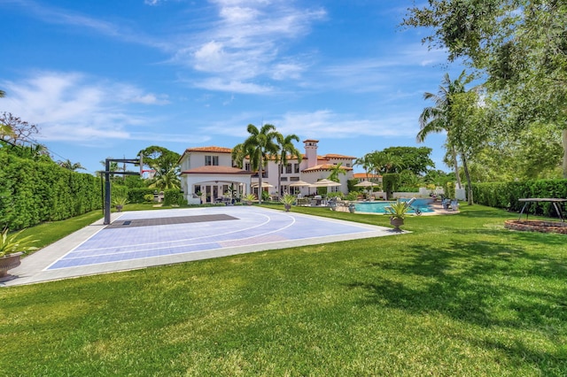 view of basketball court with a yard and a fenced in pool