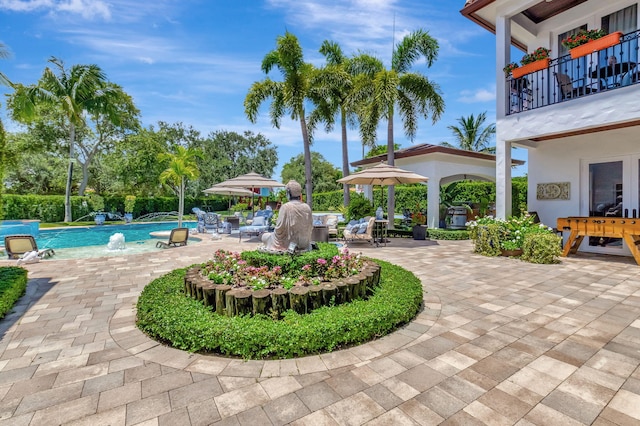 view of pool with a patio and pool water feature