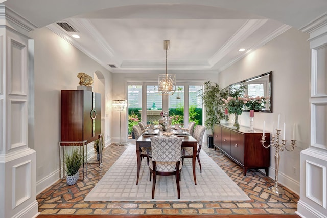 dining area with an inviting chandelier and ornamental molding