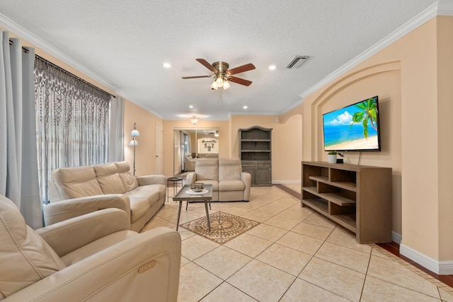 living room with light tile patterned floors, ornamental molding, a textured ceiling, and ceiling fan