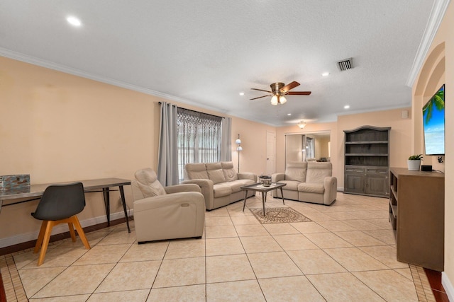 living room featuring ceiling fan, ornamental molding, a textured ceiling, and light tile patterned flooring