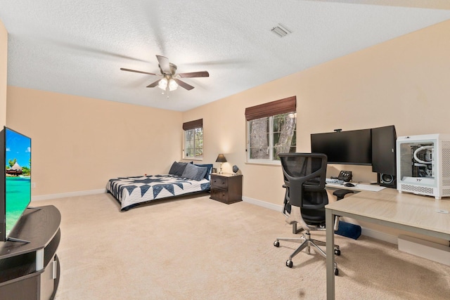 carpeted bedroom featuring a textured ceiling and ceiling fan