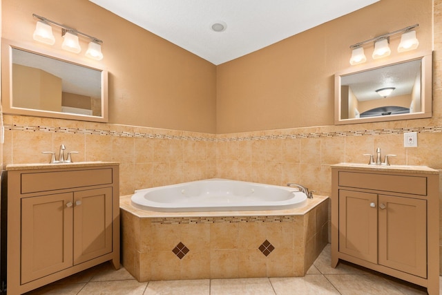 bathroom featuring tile patterned flooring, tiled bath, and tile walls