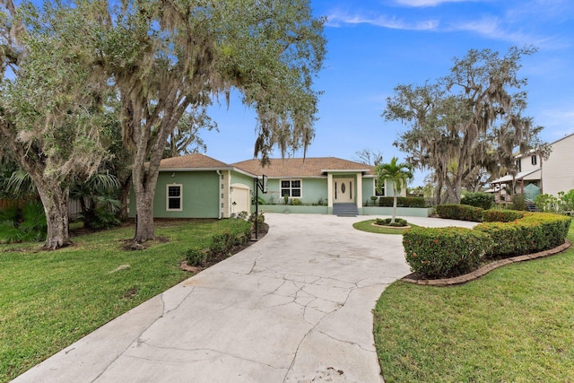 ranch-style house featuring a garage and a front lawn