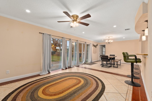 interior space featuring crown molding, ceiling fan with notable chandelier, light tile patterned floors, and a textured ceiling