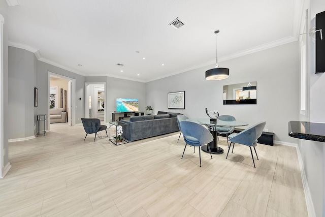 dining room featuring crown molding