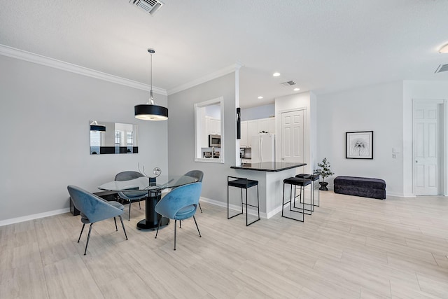 dining room featuring crown molding