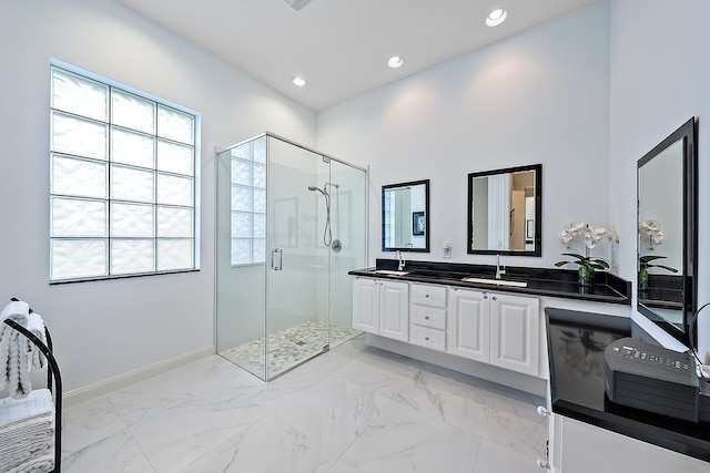 bathroom featuring vanity, an enclosed shower, and a wealth of natural light