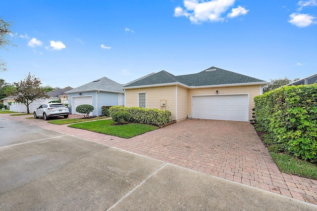 single story home featuring a garage and a front yard