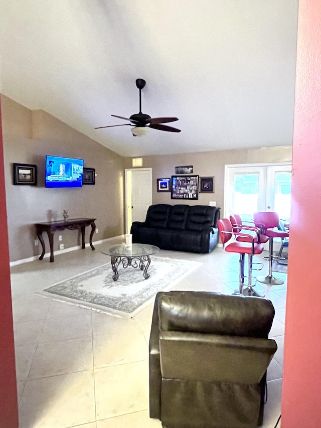 tiled living room with lofted ceiling and ceiling fan