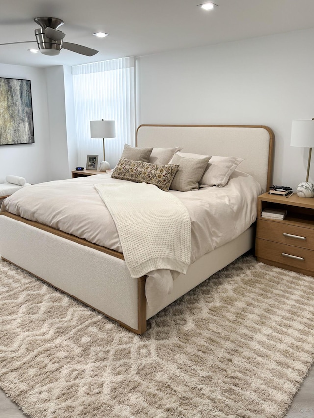 bedroom featuring ceiling fan and light hardwood / wood-style flooring