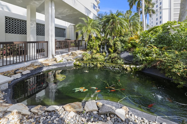 view of pool featuring a small pond