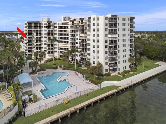 view of swimming pool with a water view and a patio