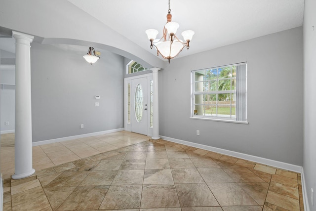 tiled entryway with ornate columns and an inviting chandelier